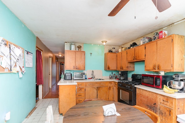 403 W School St, Plano, IL 60545 - kitchen featuring gas stove, a sink, light countertops, light floors, and ceiling fan