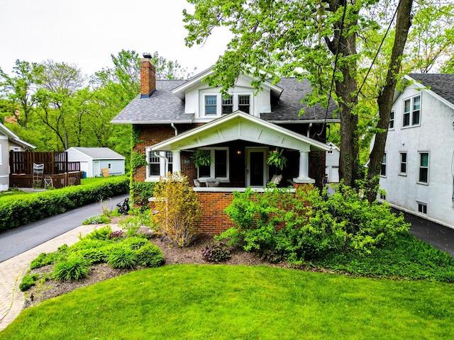 1040 Shermer Rd, Northbrook, IL 60062 - bungalow featuring a chimney, a front lawn, brick siding, and a shingled roof