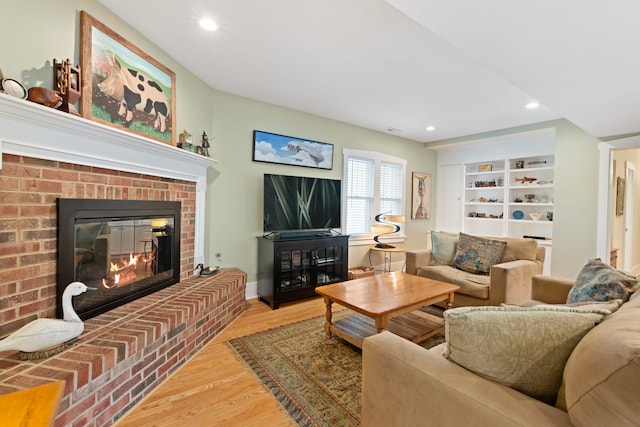 1040 Shermer Rd, Northbrook, IL 60062 - living area with wood finished floors, a brick fireplace, and recessed lighting