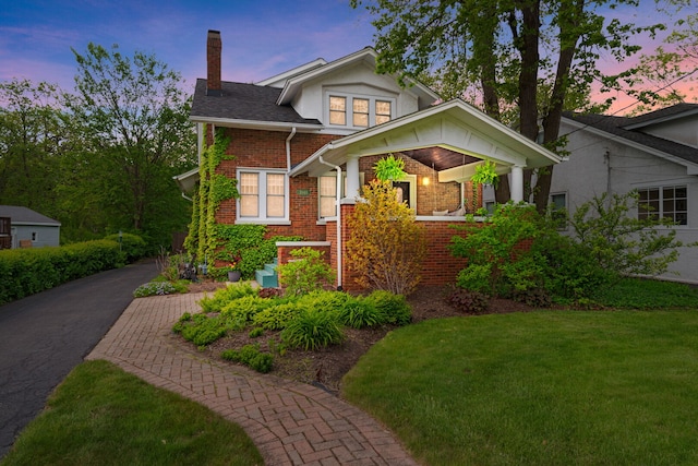 1040 Shermer Rd, Northbrook, IL 60062 - view of front of property featuring a chimney, brick siding, and a lawn