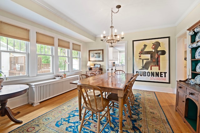 1040 Shermer Rd, Northbrook, IL 60062 - dining room featuring radiator, crown molding, a chandelier, plenty of natural light, and light wood finished floors