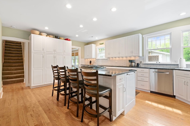 1040 Shermer Rd, Northbrook, IL 60062 - kitchen with dishwasher, a center island, a kitchen bar, light wood-style flooring, and recessed lighting