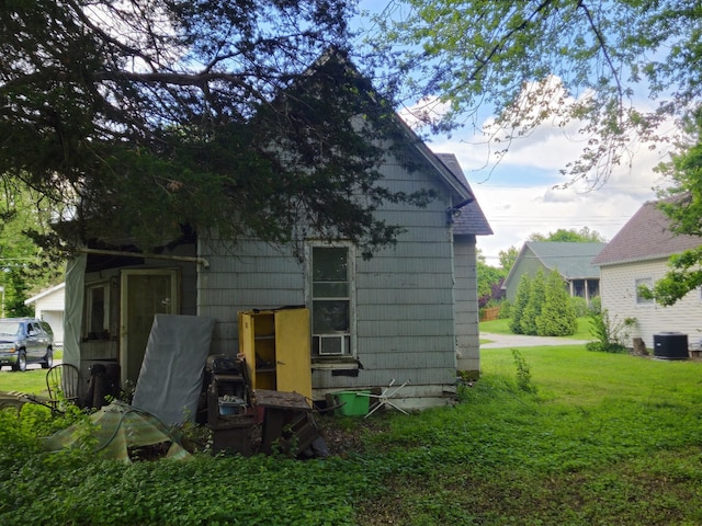 926 Division St, Charleston, IL 61920 - rear view of house with a yard and cooling unit