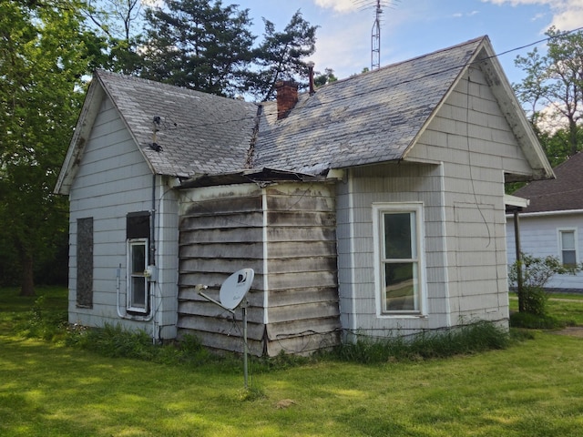 926 Division St, Charleston, IL 61920 - view of side of home with a chimney and a lawn