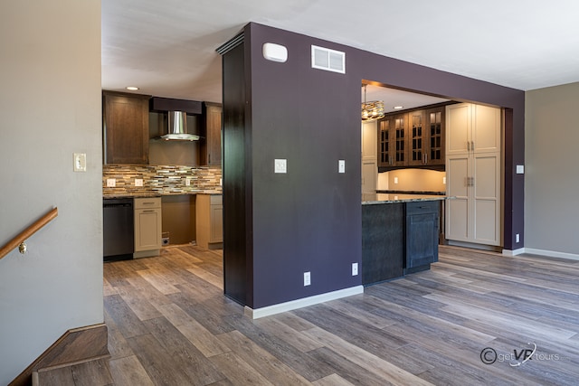 2031 W Winchester Dr, Freeport, IL 61032 - kitchen with dishwasher, wall chimney range hood, wood finished floors, tasteful backsplash, and baseboards