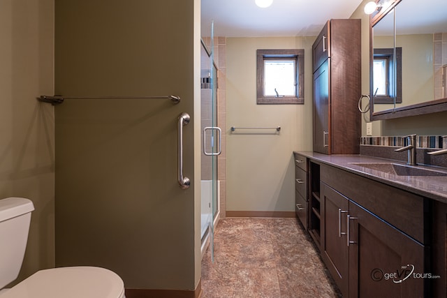 2031 W Winchester Dr, Freeport, IL 61032 - full bathroom featuring toilet, baseboards, a stall shower, and vanity