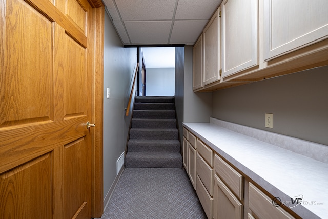 2031 W Winchester Dr, Freeport, IL 61032 - staircase with a drop ceiling, baseboards, and tile patterned floors
