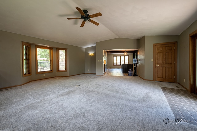 2031 W Winchester Dr, Freeport, IL 61032 - unfurnished living room with ceiling fan, lofted ceiling, baseboards, and carpet floors