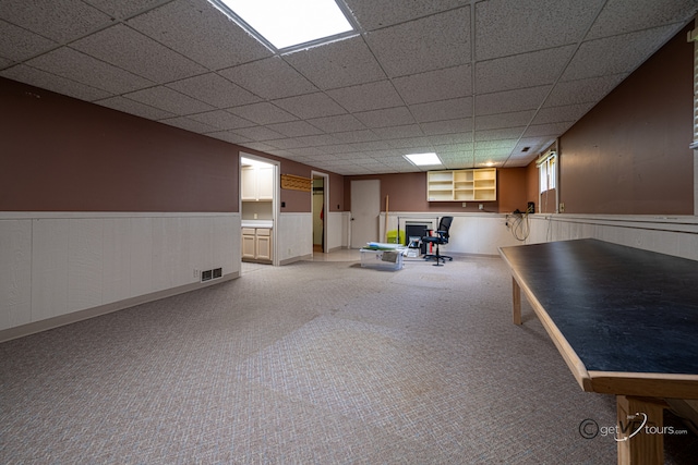 2031 W Winchester Dr, Freeport, IL 61032 - below grade area featuring carpet floors, a wainscoted wall, and a paneled ceiling