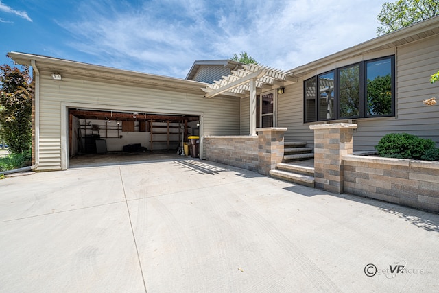 2031 W Winchester Dr, Freeport, IL 61032 - view of front of property featuring concrete driveway, a garage, and a pergola