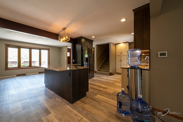 2031 W Winchester Dr, Freeport, IL 61032 - kitchen featuring stainless steel fridge with ice dispenser, dark stone counters, wood finished floors, dark brown cabinetry, and recessed lighting