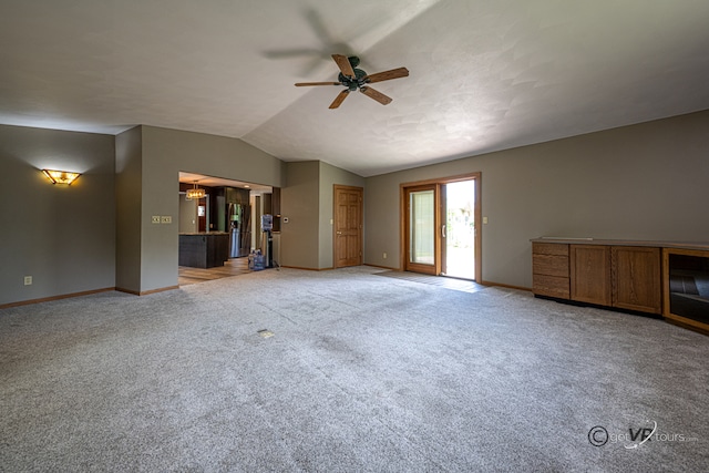2031 W Winchester Dr, Freeport, IL 61032 - unfurnished living room featuring baseboards, ceiling fan, light carpet, and lofted ceiling