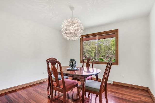 2030 Burke Dr, Winthrop Harbor, IL 60096 - dining room featuring a chandelier, wood finished floors, and baseboards