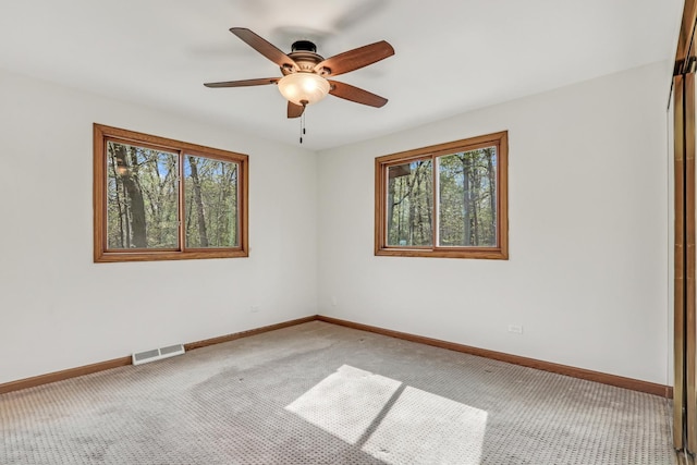 2030 Burke Dr, Winthrop Harbor, IL 60096 - carpeted empty room featuring plenty of natural light, baseboards, and ceiling fan