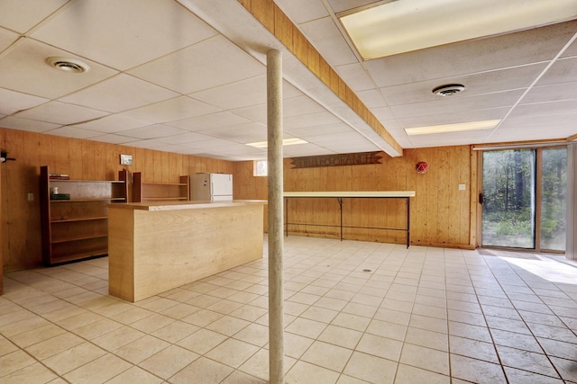 2030 Burke Dr, Winthrop Harbor, IL 60096 - kitchen with wood walls, freestanding refrigerator, a paneled ceiling, light tile patterned flooring, and open shelves