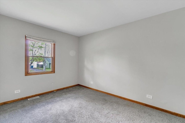 carpeted spare room with baseboards