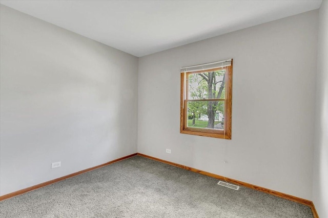 empty room featuring carpet flooring and baseboards
