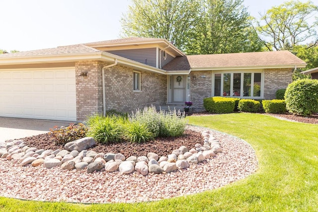 view of front of property featuring brick siding, a front yard, a garage, driveway, and a shingled roof