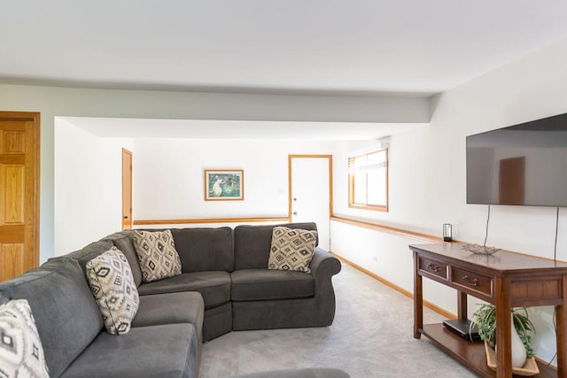 carpeted living area with baseboards