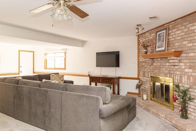 carpeted living room featuring a ceiling fan and a fireplace