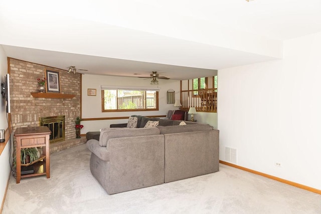 living room featuring carpet, a brick fireplace, baseboards, and ceiling fan