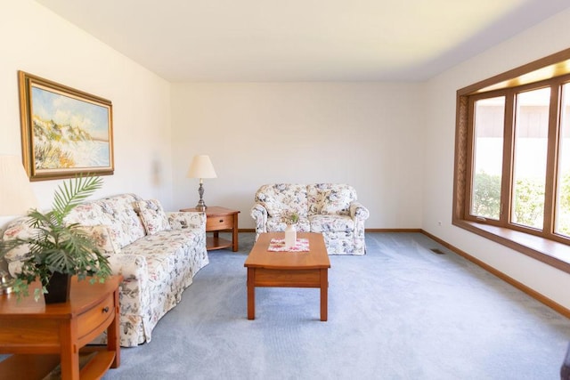 living area featuring plenty of natural light, carpet flooring, and baseboards