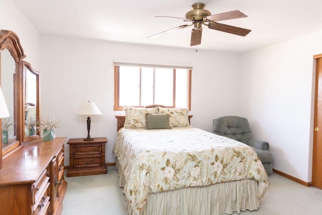 bedroom with light colored carpet, baseboards, and ceiling fan