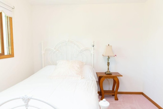 bedroom with carpet floors and baseboards