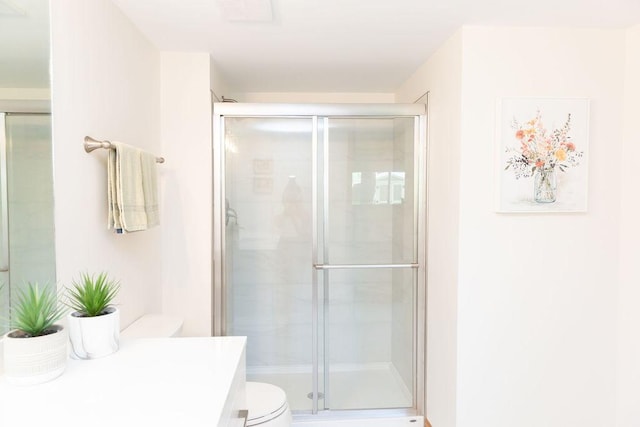 full bathroom with toilet, a shower stall, and vanity