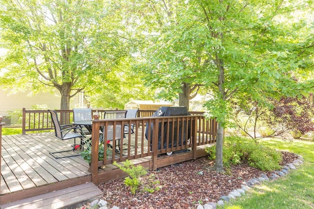 deck with a storage unit, an outdoor structure, and outdoor dining area