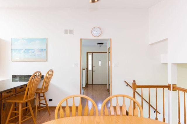 dining space featuring wood finished floors and baseboards