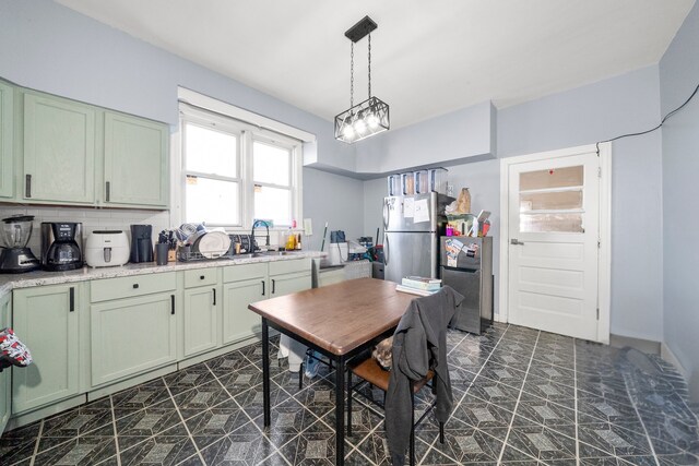 5815 W Roosevelt Rd, Cicero, IL 60804 - kitchen with freestanding refrigerator, green cabinetry, and a sink