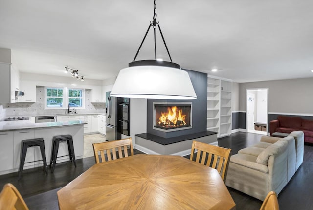 2S579 Partridge Rd, Batavia, IL 60510 - dining room featuring a large fireplace, wood finished floors, built in shelves, and recessed lighting
