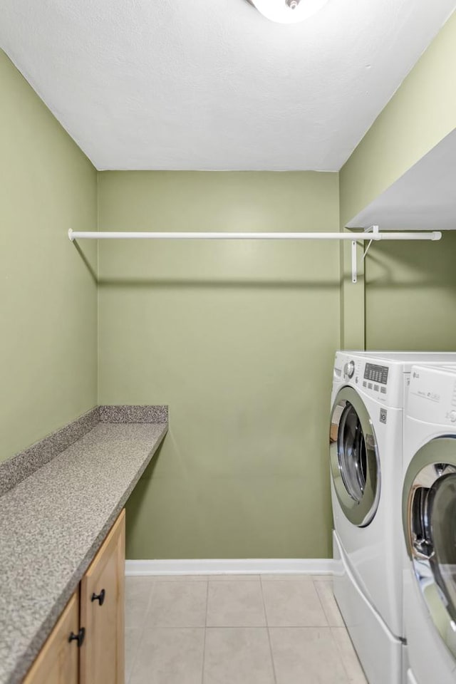2S579 Partridge Rd, Batavia, IL 60510 - laundry room featuring washing machine and clothes dryer, baseboards, light tile patterned floors, and cabinet space