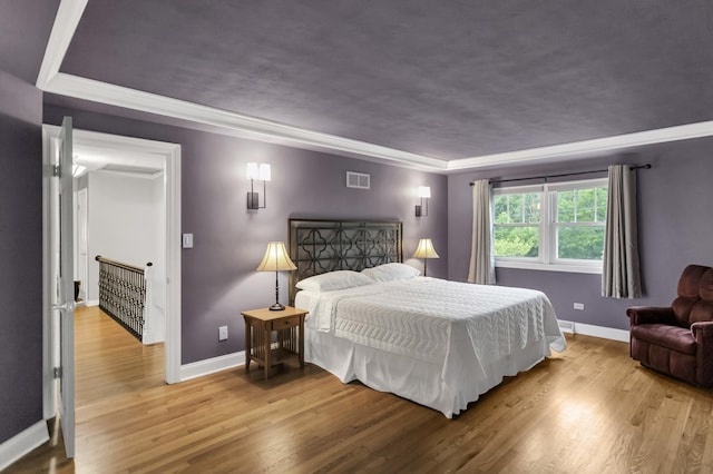2S579 Partridge Rd, Batavia, IL 60510 - bedroom featuring baseboards, wood finished floors, crown molding, and a tray ceiling