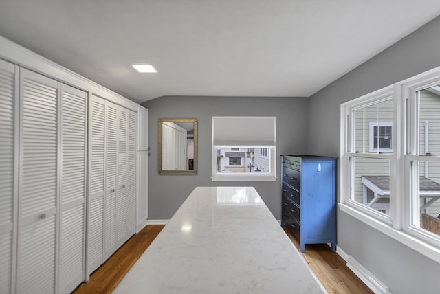 2S579 Partridge Rd, Batavia, IL 60510 - hallway featuring wood finished floors, baseboards, plenty of natural light, and vaulted ceiling