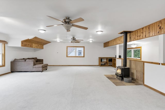 2S579 Partridge Rd, Batavia, IL 60510 - living area with a wood stove, carpet floors, a ceiling fan, and baseboards