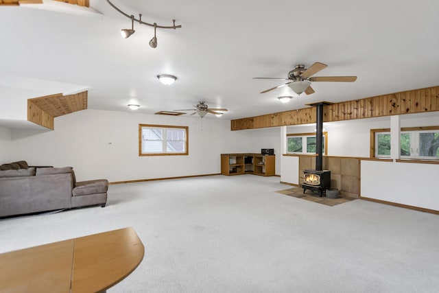 2S579 Partridge Rd, Batavia, IL 60510 - unfurnished living room with a wood stove, carpet flooring, healthy amount of natural light, and a ceiling fan