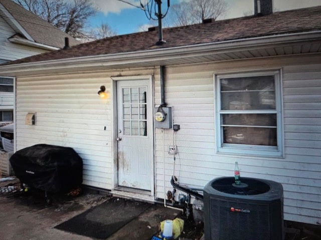 721 6th St, Lasalle, IL 61301 - property entrance with cooling unit and roof with shingles