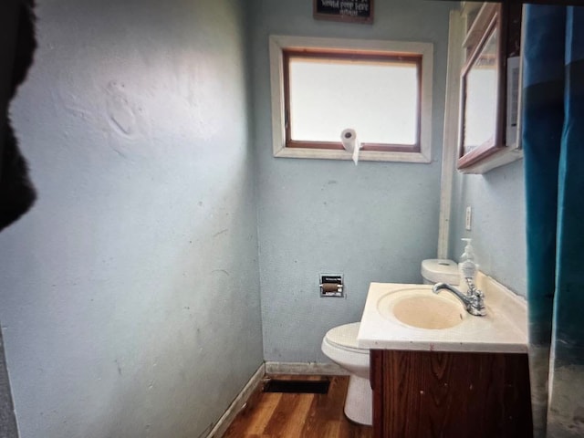 721 6th St, Lasalle, IL 61301 - bathroom with toilet, wood finished floors, baseboards, and vanity