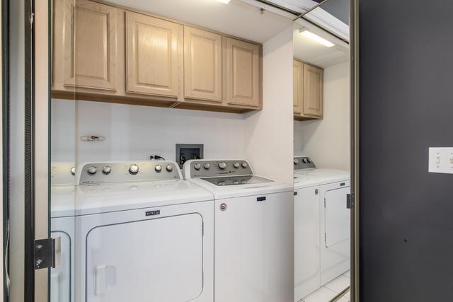 400 S NW Hwy Unit 309, Park Ridge, IL 60068 - clothes washing area featuring washing machine and clothes dryer and cabinet space