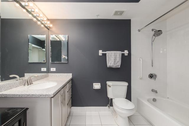 400 S NW Hwy Unit 309, Park Ridge, IL 60068 - bathroom featuring tile patterned flooring, toilet, vanity, shower / bath combination, and baseboards