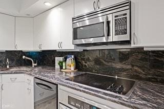 1430 N Astor St Unit 7A, Chicago, IL 60610 - kitchen featuring appliances with stainless steel finishes, white cabinets, backsplash, a sink, and stone countertops