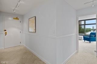 1430 N Astor St Unit 7A, Chicago, IL 60610 - hallway featuring rail lighting, baseboards, and carpet