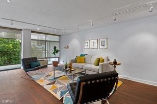 1430 N Astor St Unit 7A, Chicago, IL 60610 - living room featuring track lighting, wood finished floors, and baseboards