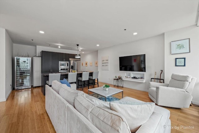 653 N Kingsbury St Unit 706, Chicago, IL 60654 - living room with beverage cooler, light wood-style flooring, recessed lighting, and baseboards