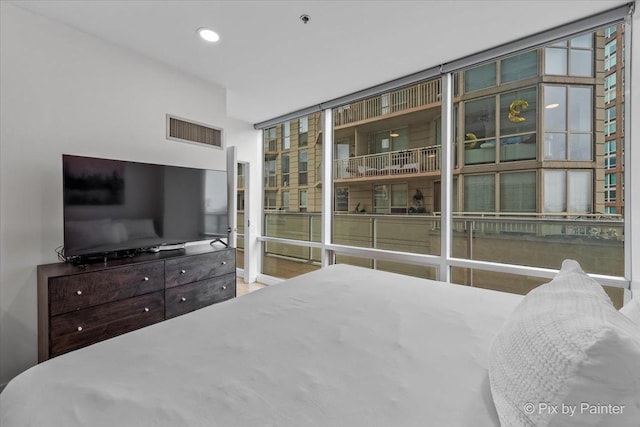 653 N Kingsbury St Unit 706, Chicago, IL 60654 - bedroom featuring a wall of windows and recessed lighting