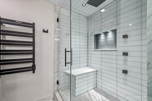 653 N Kingsbury St Unit 706, Chicago, IL 60654 - bathroom with marble finish flooring, a shower stall, radiator heating unit, a towel warmer, and baseboards