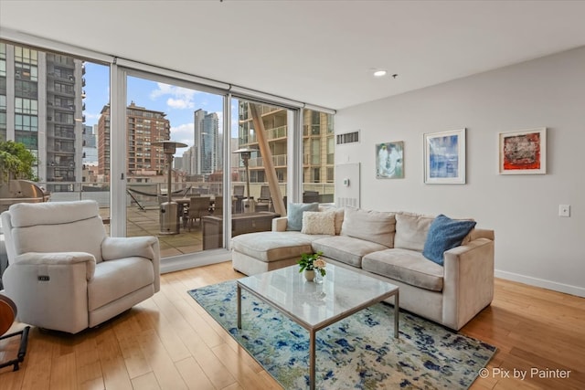 653 N Kingsbury St Unit 706, Chicago, IL 60654 - living room featuring a view of skyline, expansive windows, wood finished floors, baseboards, and recessed lighting