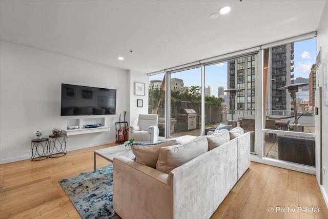 653 N Kingsbury St Unit 706, Chicago, IL 60654 - living area featuring hardwood / wood-style floors, plenty of natural light, a wall of windows, and recessed lighting